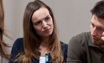 Woman looking at man with confused facial expression