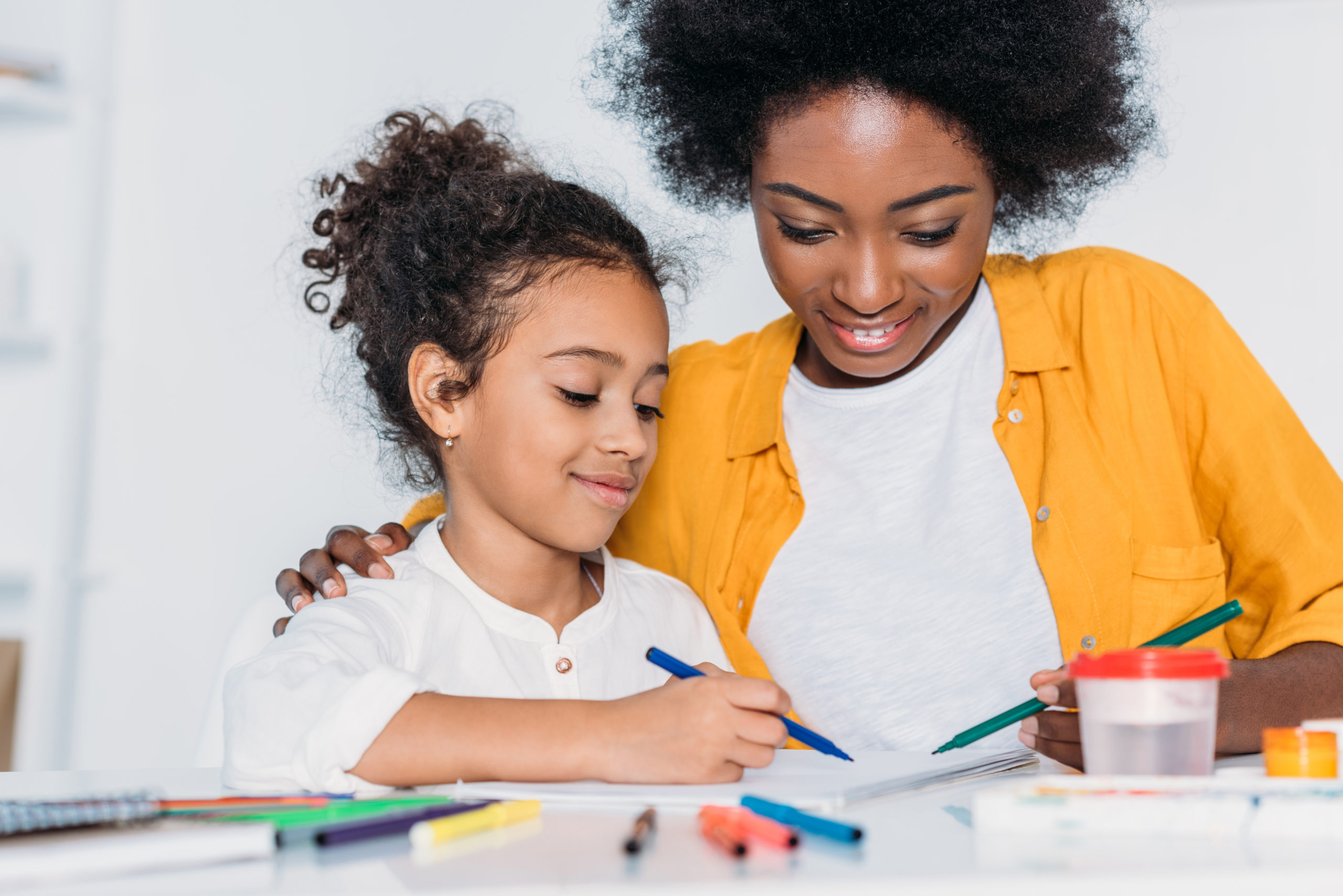 Single mother helping her daughter with her homework