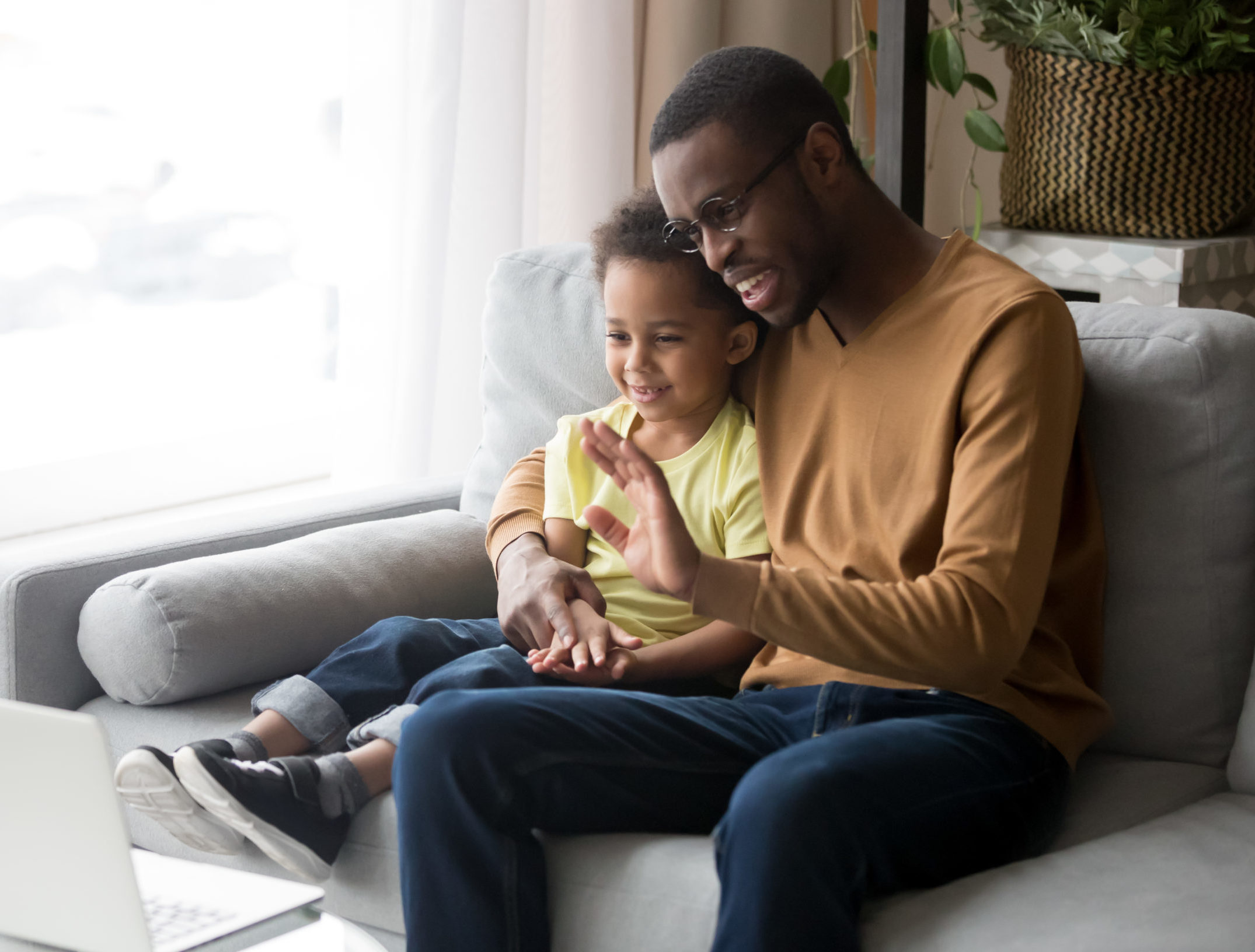 Father and son on a video call with family